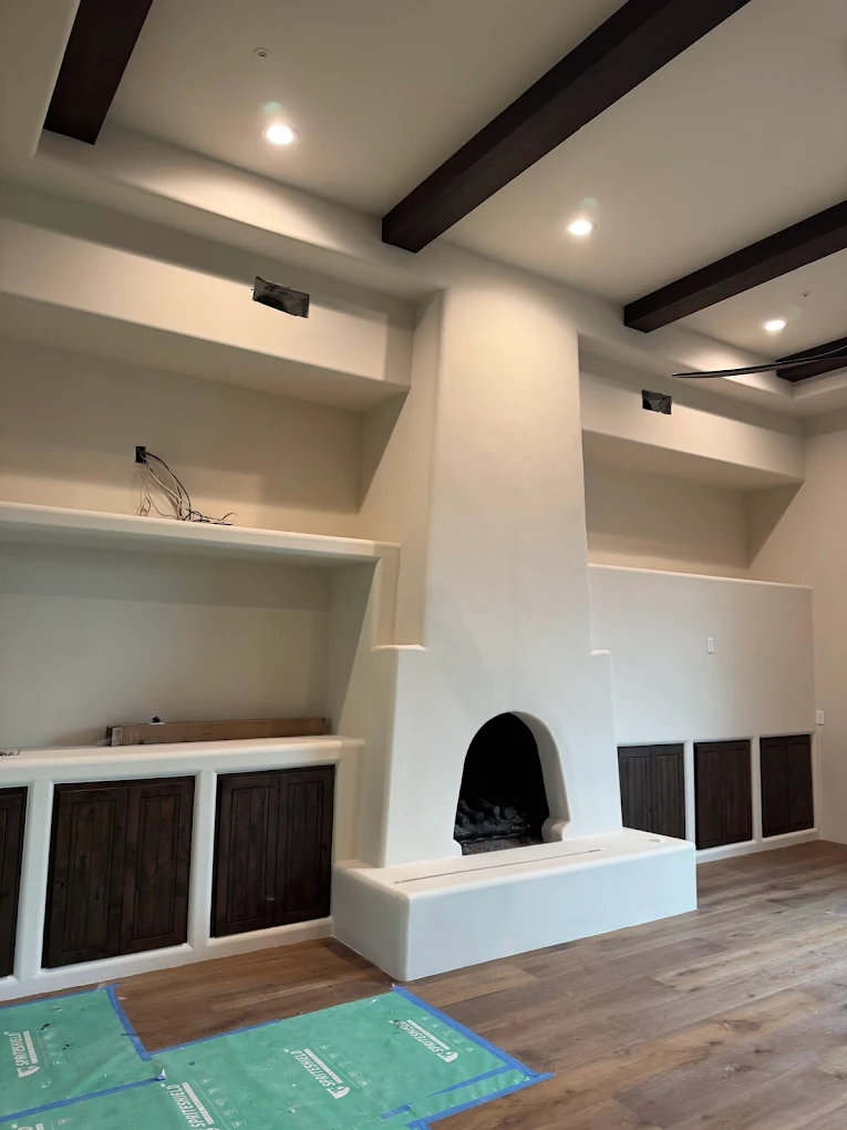 Finished living room with smooth-finish fireplace and built-ins